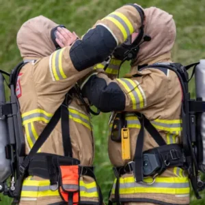 Firefighters check each others breathing apparatus.