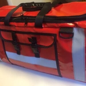 Trauma Care bag The new water/contaminants resistant trauma care bag has been designed to enable easy access to the components pouches which are stored individually within the main section. Made from durable PVC tarpaulin the sides are also padded affording addition structure and protection. The cylinder stowage section is zipped and fixed to prevent movement and the bag can be carried as a grip or on the back as a rucksack, the shoulder straps fold away completely to prevent snagging/trip hazard. A comprehensive and user friendly stowage solution for this crucial equipment.
